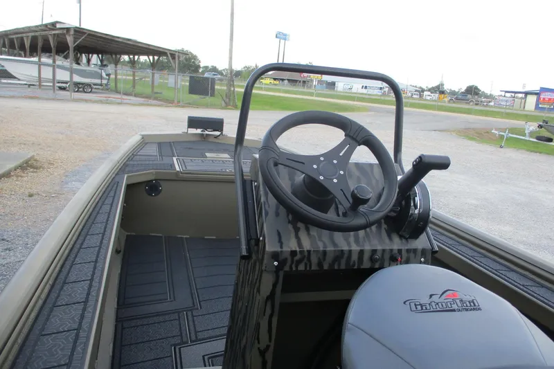 Slide: The Image of 2026 Gator Tail 1854 Extreme CC boat interior with steering wheel and controls. - 8