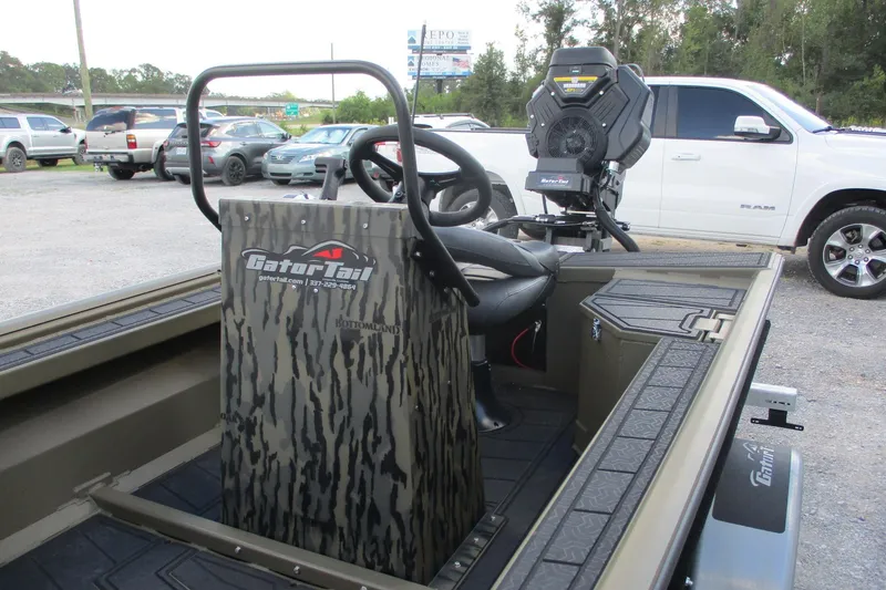 Slide: The Image of 2026 Gator Tail 1854 Extreme CC boat interior with steering console and motor. - 9