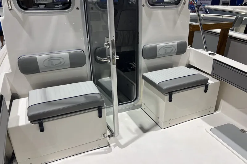 Slide: The Image of Interior of 2026 Defiance Admiral 220 EX boat, featuring steering wheel and control panel. - 11