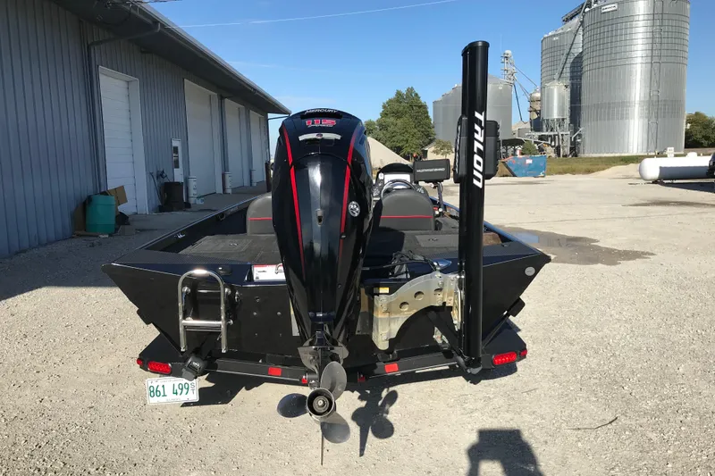 Slide: The Image of 2016 Ranger RT188 boat with Mercury engine, parked near industrial buildings. - 10
