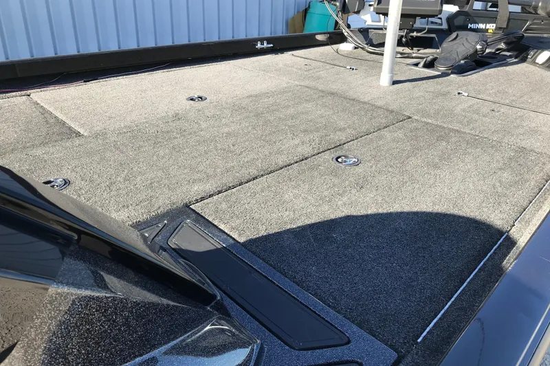 Slide: The Image of 2016 Ranger RT188 boat deck with carpeted surface and storage compartments. - 14