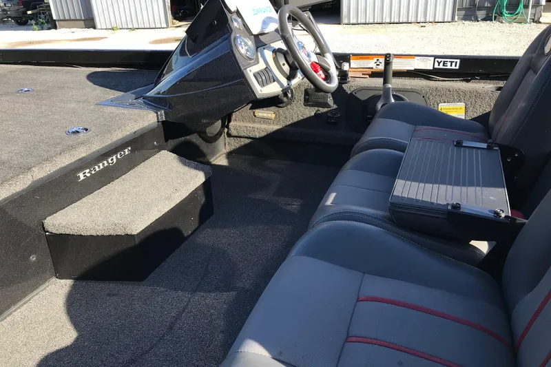 Slide: The Image of 2016 Ranger RT188 boat interior with steering wheel and seating area. - 19