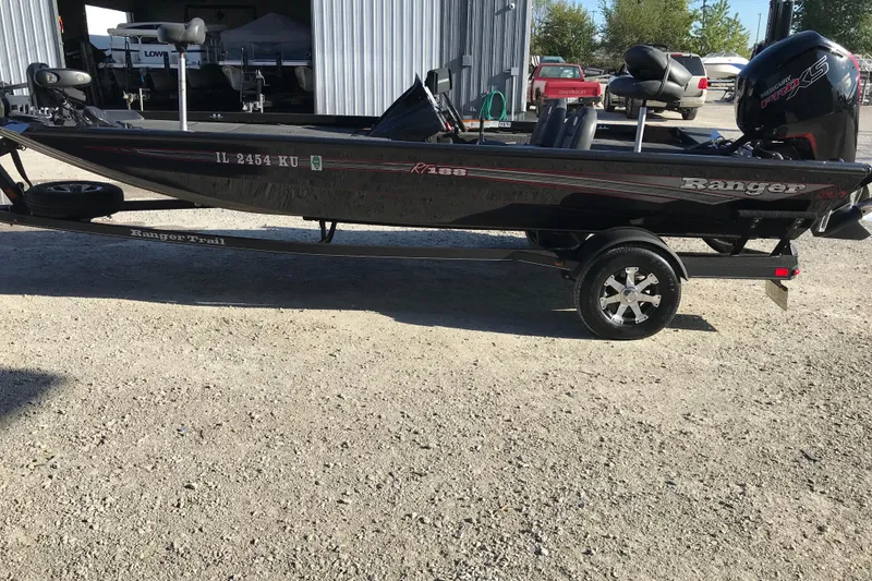 Slide: The Image of 2016 Ranger RT188 boat on trailer, parked outdoors, with visible motor and equipment. - 21