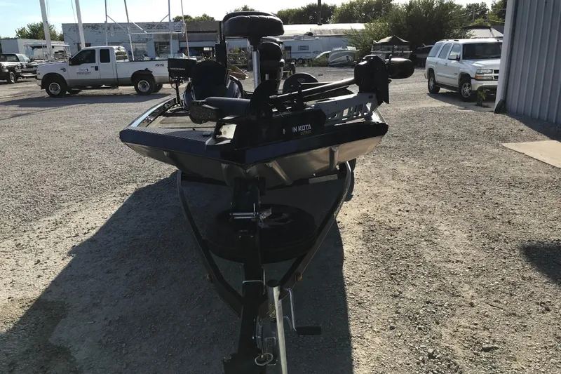 Slide: The Image of 2016 Ranger RT188 boat on trailer in outdoor lot with vehicles. - 8