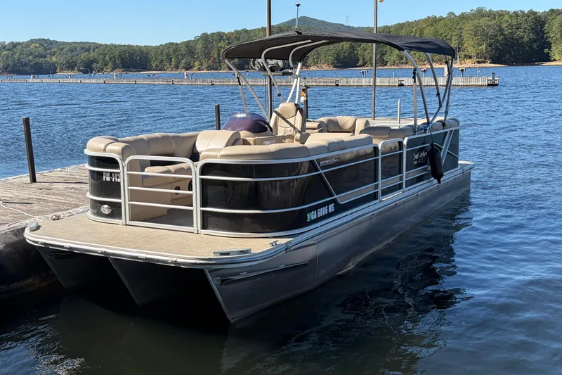 The Image of 2021 G3 SunCatcher Fusion 325RCX pontoon boat docked on a serene lake. - 0
