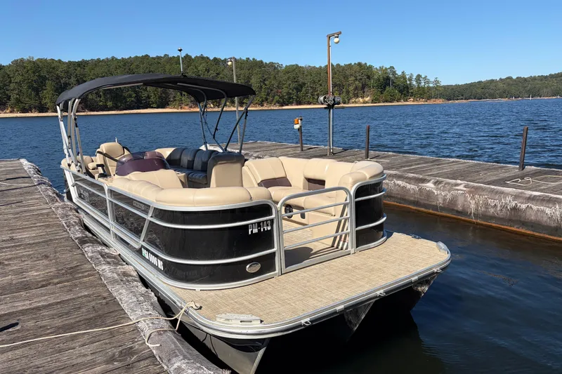 Slide: The Image of 2021 G3 SunCatcher Fusion 325RCX pontoon boat docked on a serene lake. - 2