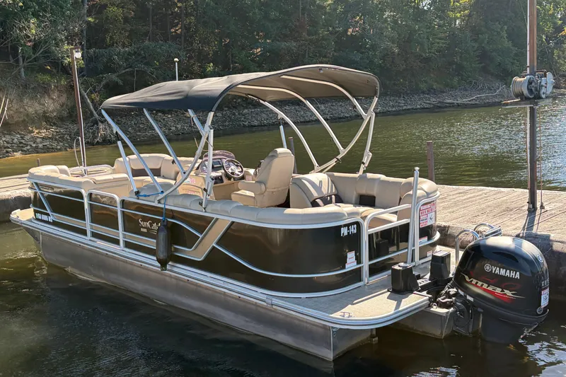 Slide: The Image of 2021 G3 SunCatcher Fusion 325RCX pontoon boat docked by a lakeside. - 4