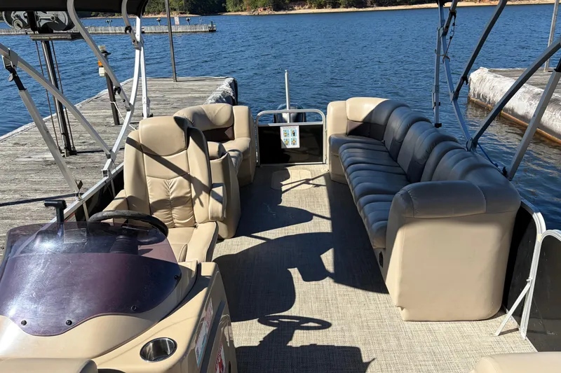 Slide: The Image of 2021 G3 SunCatcher Fusion 325RCX pontoon boat interior with beige seating at dock. - 7