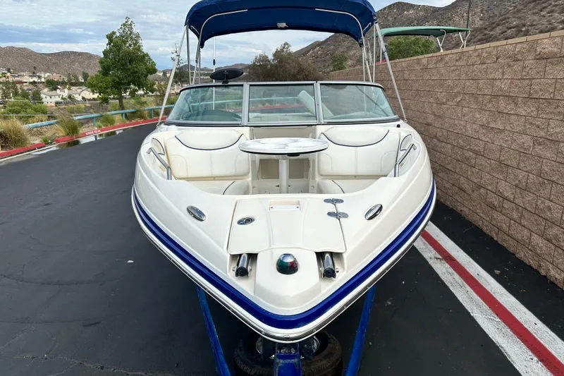 Slide: The Image of 2006 Rinker 226 Captiva Bowrider interior with white seating and blue accents. - 10