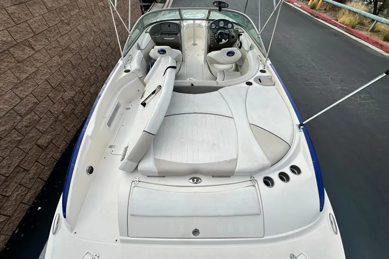 Slide: The Image of 2006 Rinker 226 Captiva Bowrider interior with white seating and dashboard details. - 12