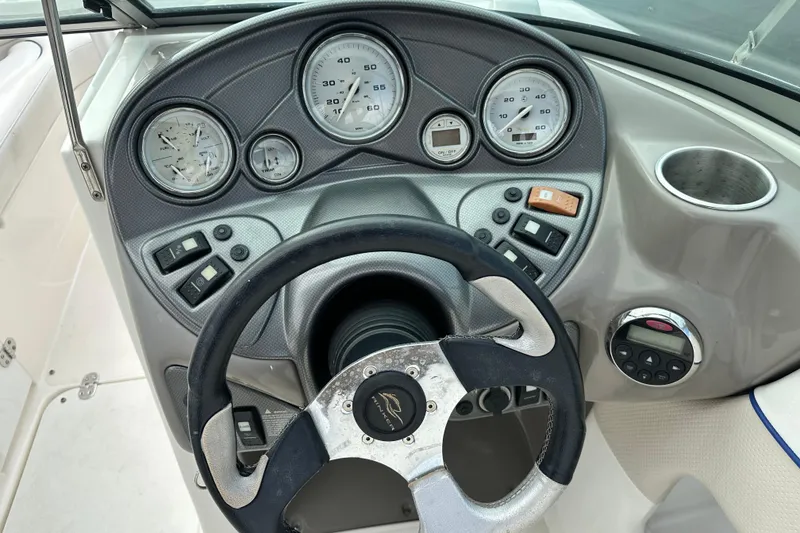 Slide: The Image of 2006 Rinker 226 Captiva Bowrider dashboard with steering wheel and gauges. - 14