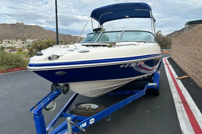 Slide: The Image of 2006 Rinker 226 Captiva Bowrider boat interior with seating and steering wheel. - 8