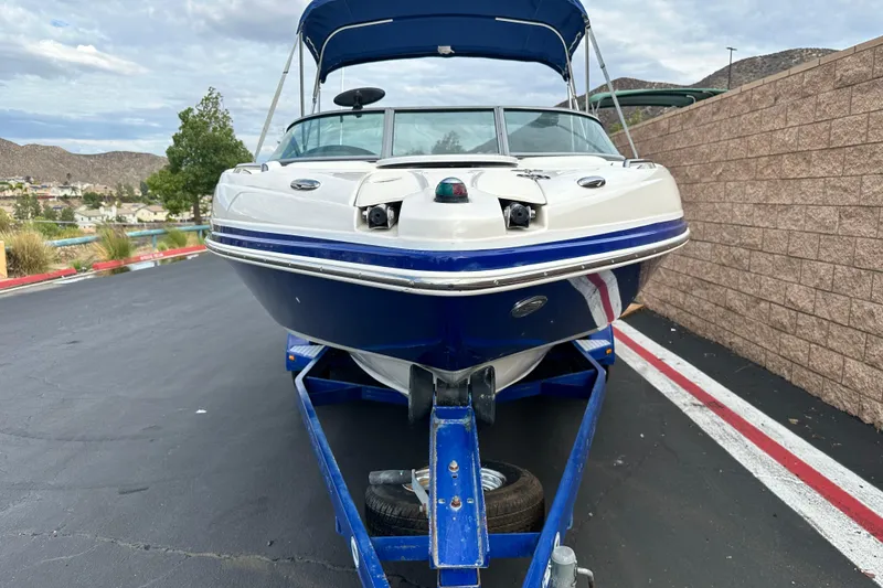 Slide: The Image of 2006 Rinker 226 Captiva Bowrider interior with white seating and dashboard view. - 9