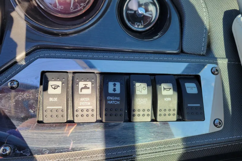 Slide: The Image of Control panel of a 2018 Monterey 278SS Super Sport boat with various switches. - 16