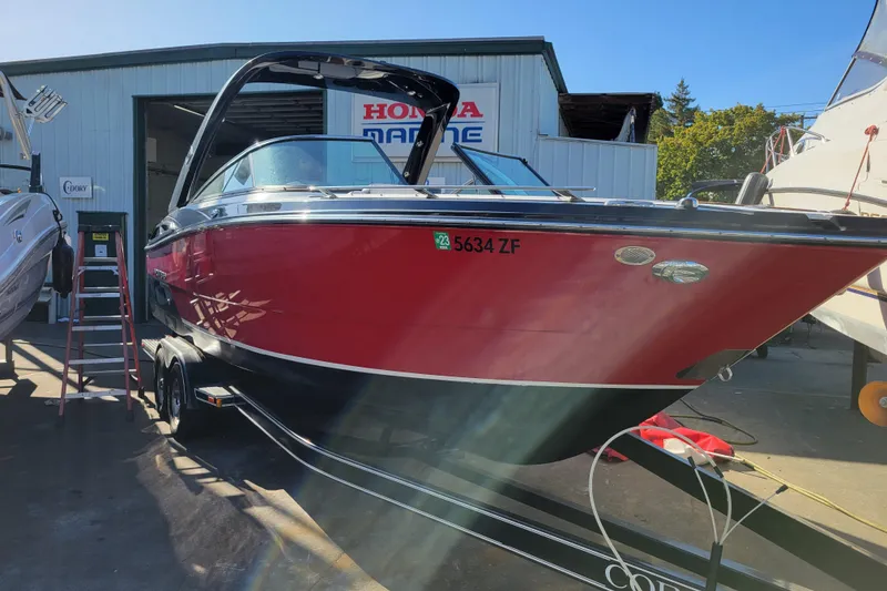 Slide: The Image of 2018 Monterey 278SS Super Sport boat in a marina, red and black exterior. - 2