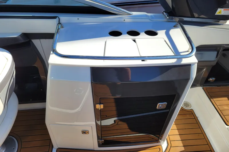 Slide: The Image of 2018 Monterey 278SS Super Sport boat interior with sleek cabinetry and wood flooring. - 24