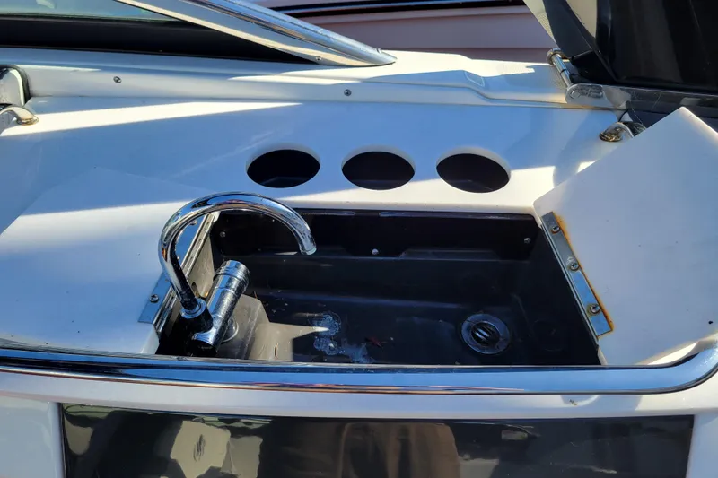Slide: The Image of 2018 Monterey 278SS Super Sport boat sink with chrome faucet and storage compartment. - 25