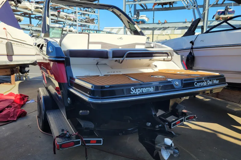 Slide: The Image of 2018 Monterey 278SS Super Sport boat in marina, rear view with wooden deck. - 4