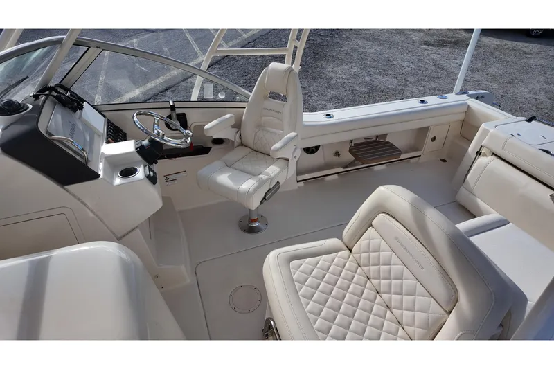 Slide: The Image of 2019 Grady-White Freedom 235 boat interior with luxurious seating and helm. - 17