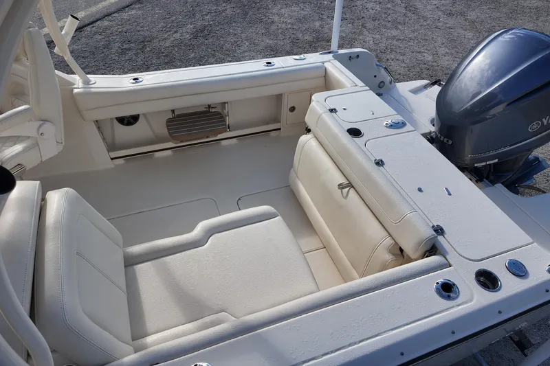 Slide: The Image of 2019 Grady-White Freedom 235 boat interior with seating and Yamaha outboard motor. - 18