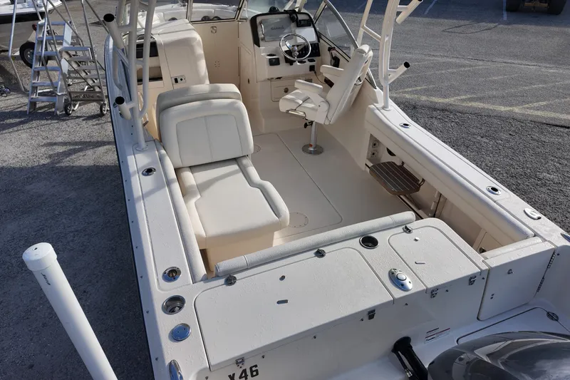 Slide: The Image of 2019 Grady-White Freedom 235 boat interior with seating and steering console. - 19
