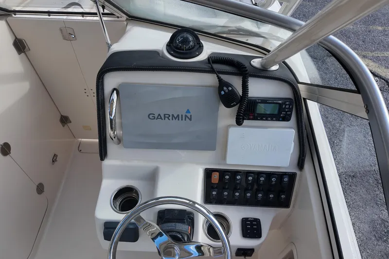 Slide: The Image of 2019 Grady-White Freedom 235 boat dashboard with Garmin navigation system and Yamaha controls. - 20