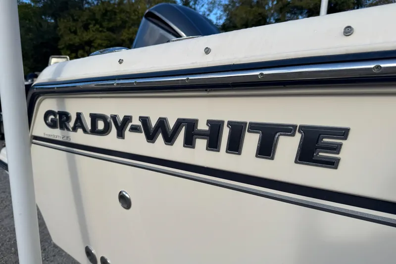 Slide: The Image of 2019 Grady-White Freedom 235 boat side view with logo detail. - 22