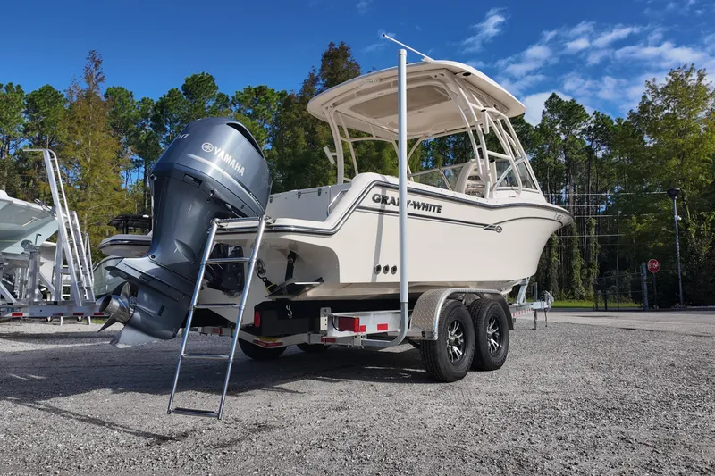 Slide: The Image of 2019 Grady-White Freedom 235 boat on trailer with Yamaha outboard motor, parked outdoors. - 3