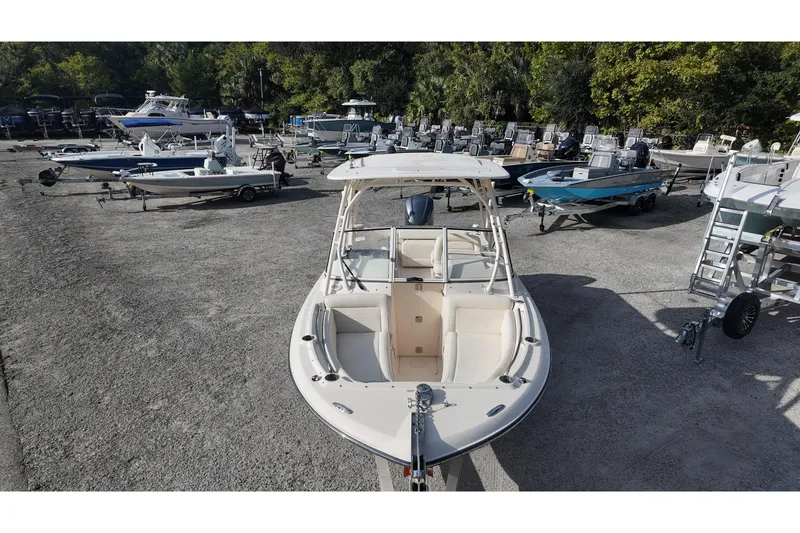Slide: The Image of 2019 Grady-White Freedom 235 boat in a marina with other vessels. - 8