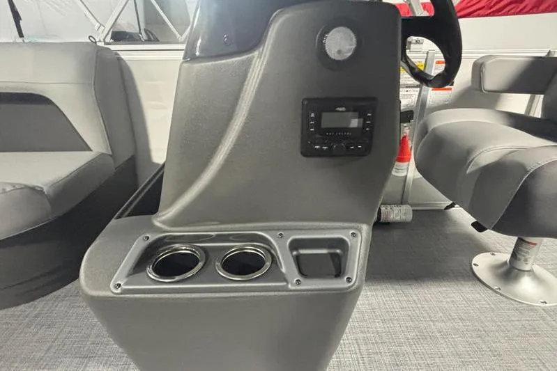 Slide: The Image of 2026 Sun Tracker Party Barge 16 DLX interior with console, cup holders, and seating. - 2