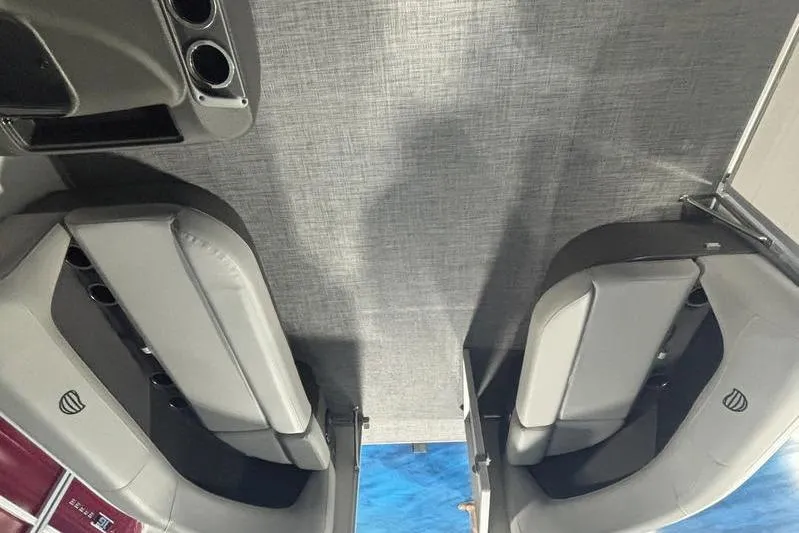 Slide: The Image of Interior view of 2026 Sun Tracker Party Barge 16 DLX with gray seating and cup holders. - 4