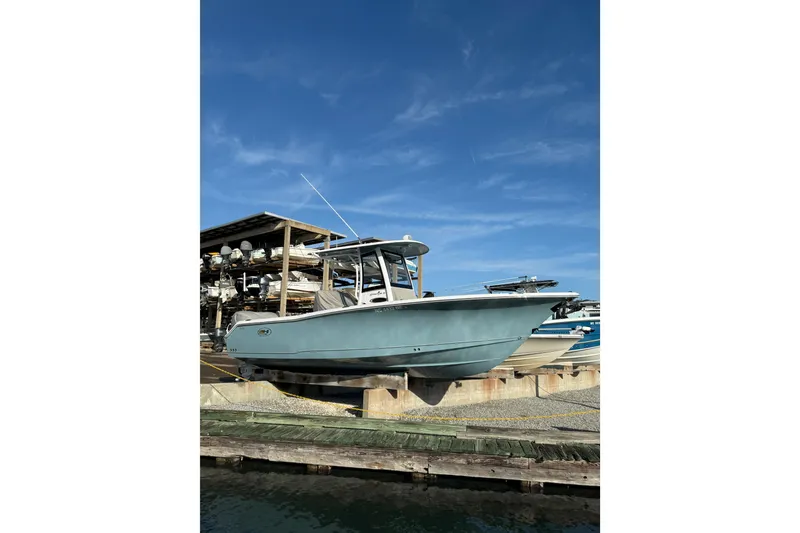 The Image of 2025 Sea Hunt Gamefish 25 boat docked under clear blue sky. - 1