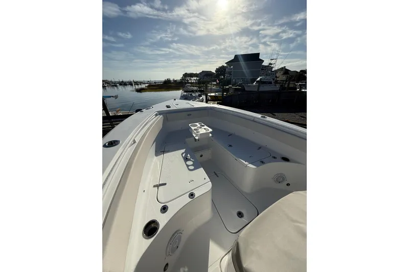 Slide: The Image of 2025 Sea Hunt Gamefish 25 boat docked under a sunny sky. - 10