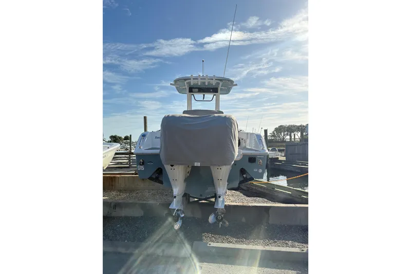 Slide: The Image of 2025 Sea Hunt Gamefish 25 boat docked, rear view with covered engines. - 3
