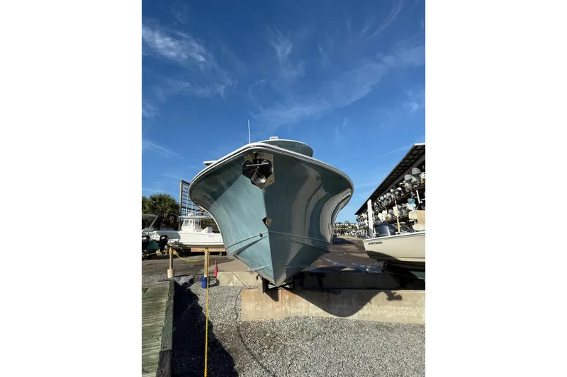 Slide: The Image of 2025 Sea Hunt Gamefish 25 boat on dry dock under clear blue sky. - 5