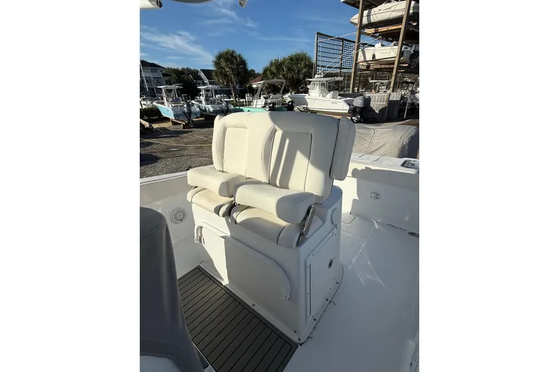 Slide: The Image of 2025 Sea Hunt Gamefish 25 boat with dual cushioned seats, docked in a marina. - 8