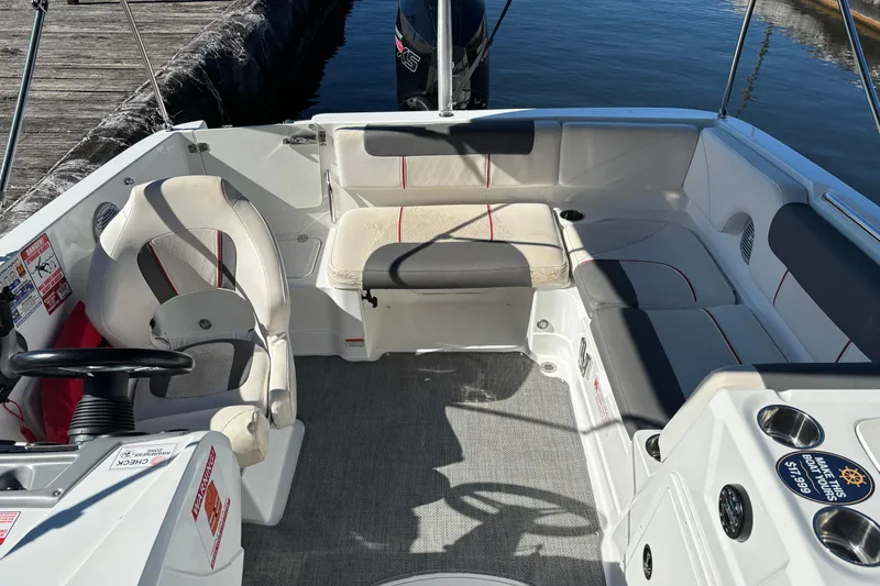 Slide: The Image of Interior of a 2021 Tahoe 1950 boat with seating and steering wheel. - 5
