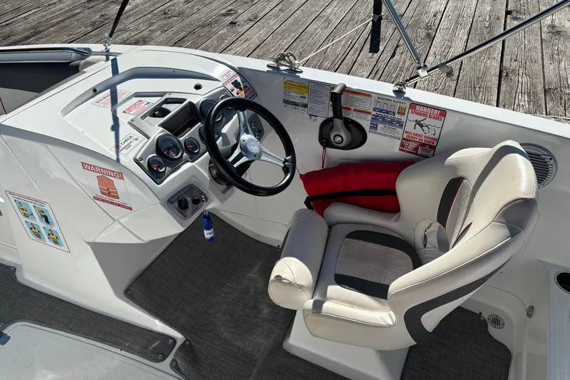 Slide: The Image of Cockpit of a 2021 Tahoe 1950 boat with steering wheel and control panel. - 7