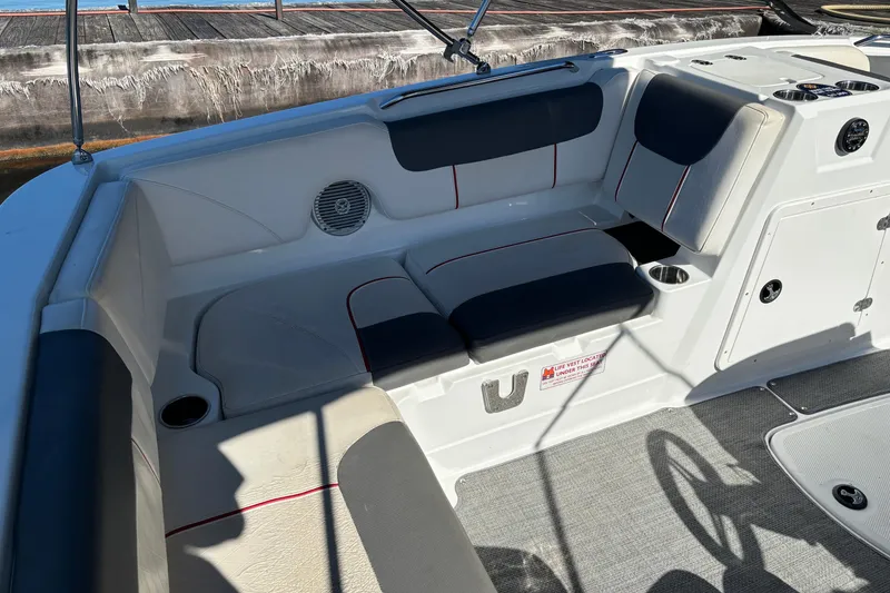 Slide: The Image of Interior of a 2021 Tahoe 1950 boat with cushioned seating and cup holders. - 8