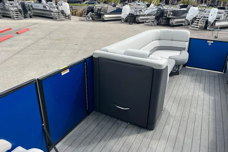 Slide: The Image of 2021 Godfrey Monaco 255 RL Tri Toon boat interior with gray seating and blue panels. - 10