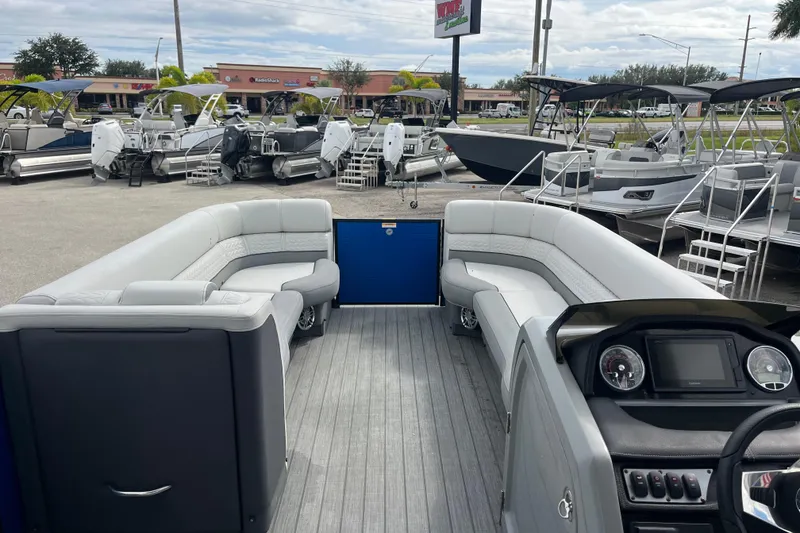 Slide: The Image of 2021 Godfrey Monaco 255 RL Tri Toon boat interior with spacious seating and modern dashboard. - 11