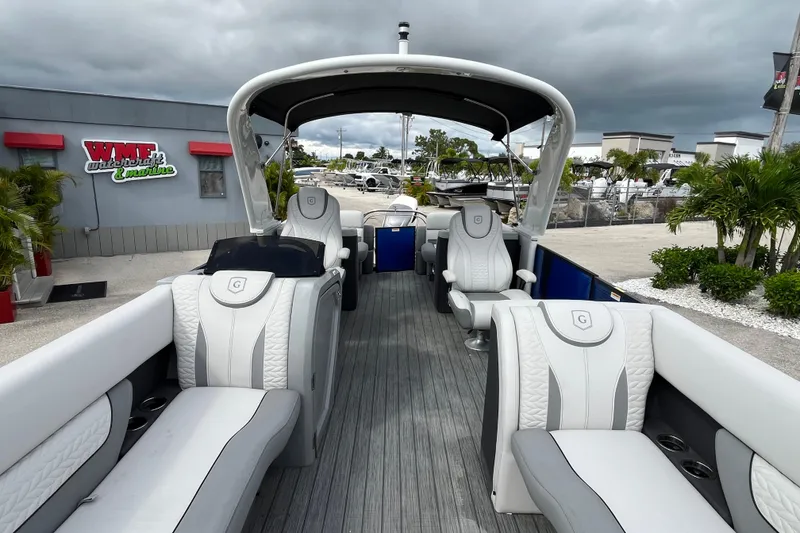 Slide: The Image of 2021 Godfrey Monaco 255 RL Tri Toon boat with luxurious seating and canopy. - 12