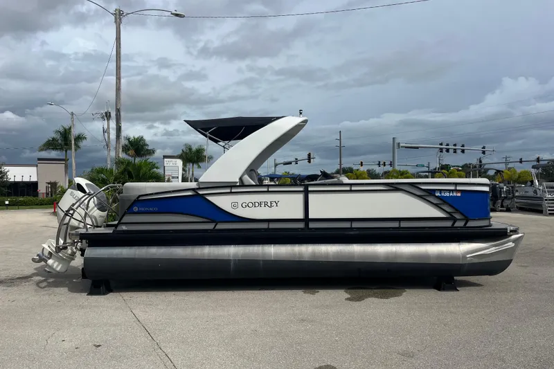 Slide: The Image of 2021 Godfrey Monaco 255 RL Tri Toon boat on display in a parking lot. - 4