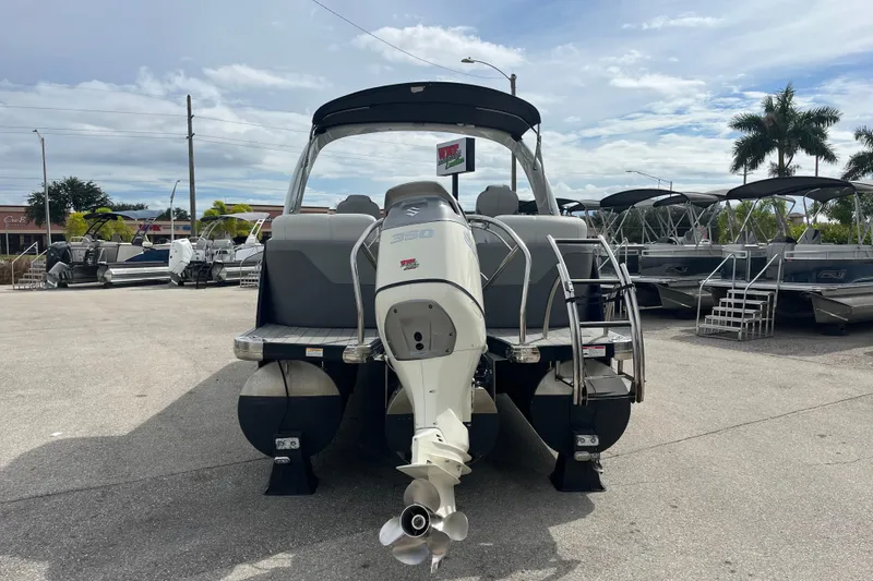 Slide: The Image of 2021 Godfrey Monaco 255 RL Tri Toon boat with Suzuki 350 engine, displayed outdoors. - 6