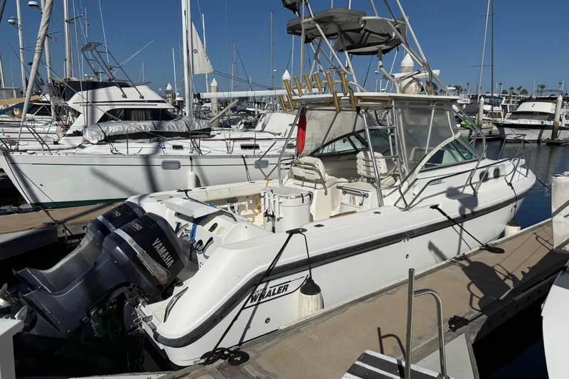 The Image of 2000 Boston Whaler 295 Conquest docked at marina with Yamaha outboard engines. - 0