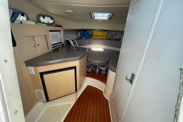 Slide: The Image of Helm of 2000 Boston Whaler 295 Conquest with steering wheel and navigation equipment. - 6