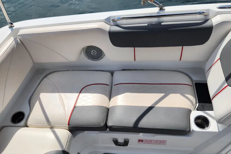 Slide: The Image of Boat seating area in a 2021 Tahoe 1950, featuring cushioned seats and cup holders. - 10