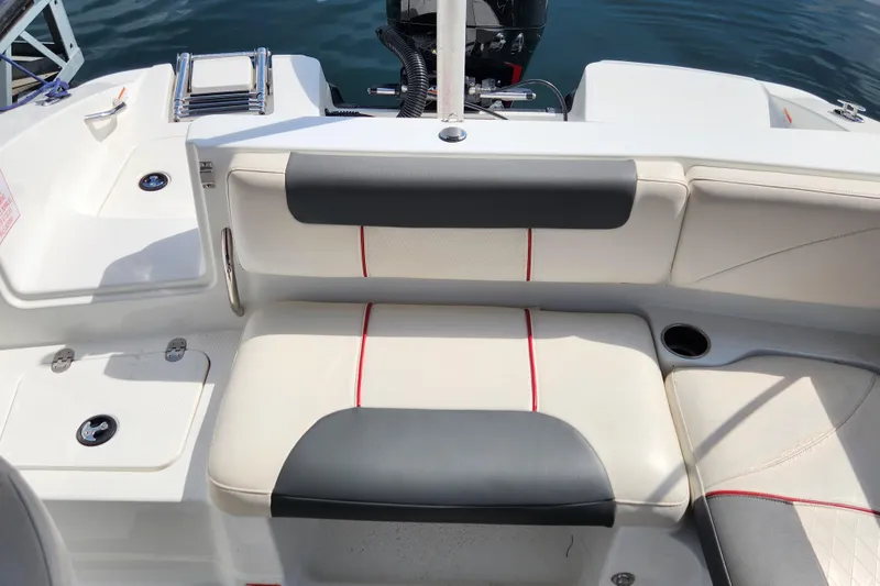 Slide: The Image of 2021 Tahoe 1950 boat interior with cushioned seating and cup holder. - 13