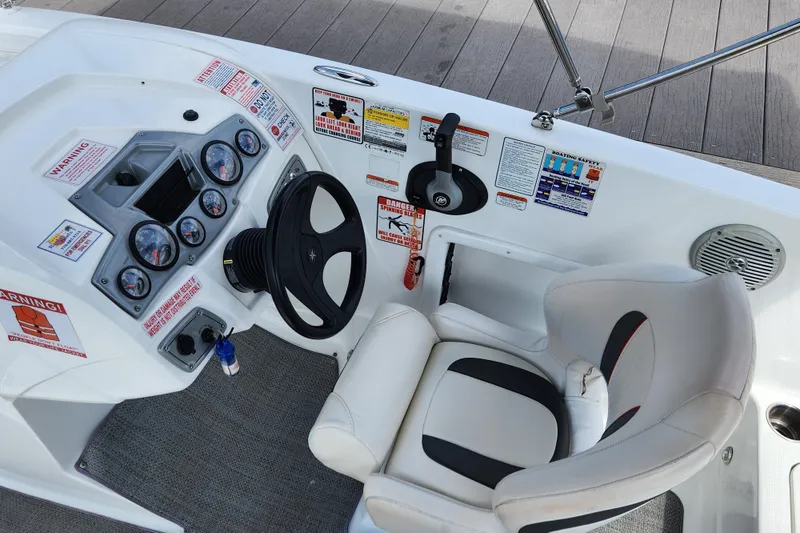 Slide: The Image of Cockpit of a 2021 Tahoe 1950 boat with steering wheel and control panel. - 14
