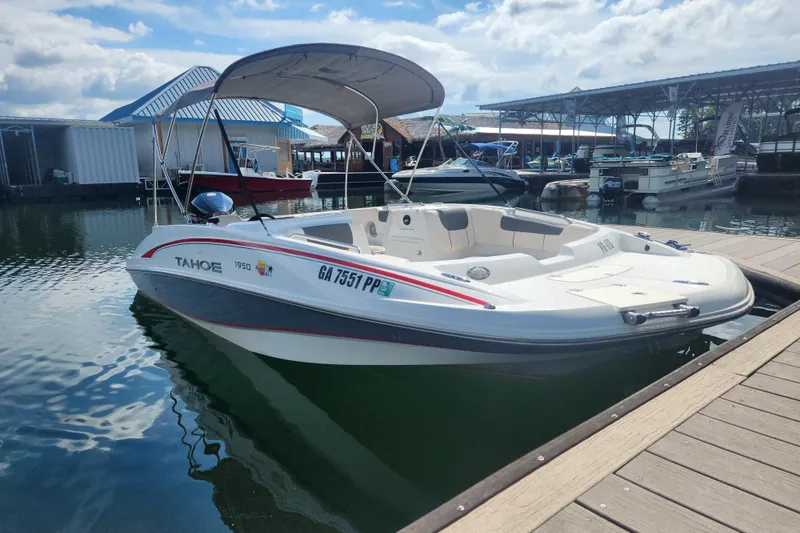 Slide: The Image of Tahoe 1950 boat, 2021 model, docked at marina under sunny skies. - 2